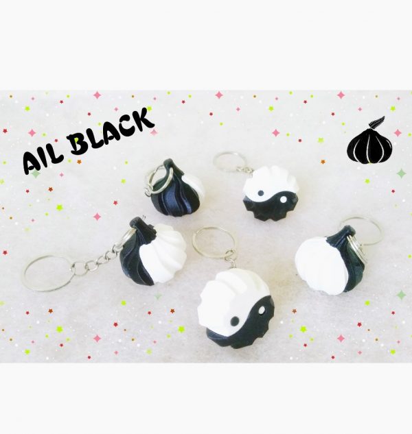 Porte-clés en forme de bulbe d'ail, moitié blanc, moitié noir basé sur le symbole du yin yang